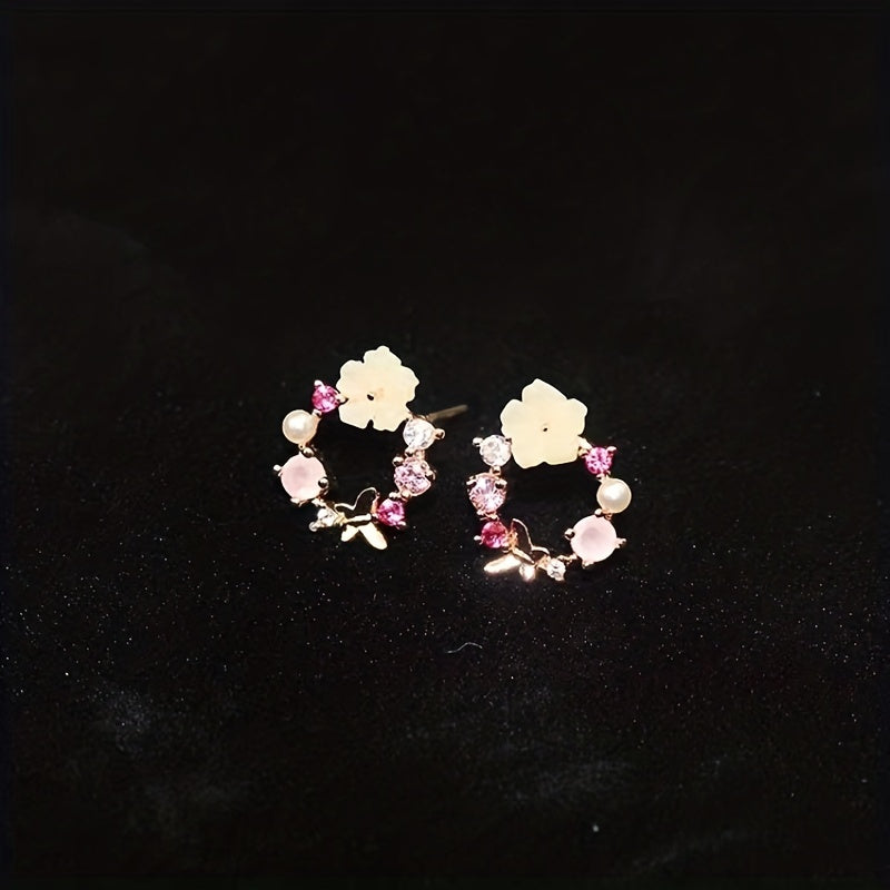 Stud earrings with floral motif and gemstone accents