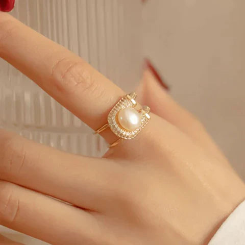 Ring with split band, central pearl and pavé setting