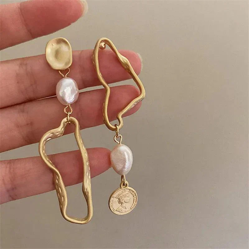 Asymmetric baroque pearl earrings with gold accents