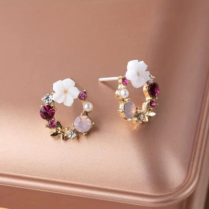 Stud earrings with floral motif and gemstone accents